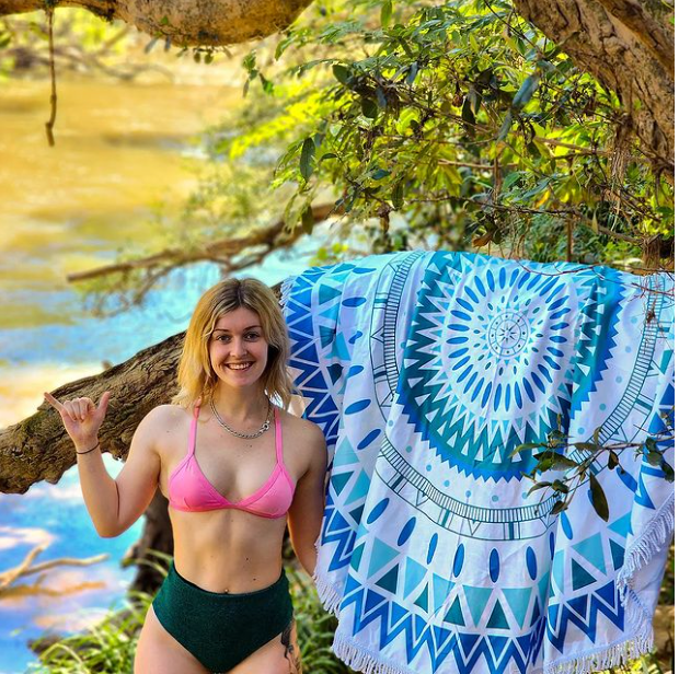 Bohemian blue beach towel on a beach backdrop 